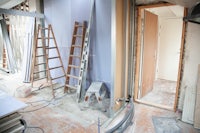 a room being remodeled with a ladder and ladders